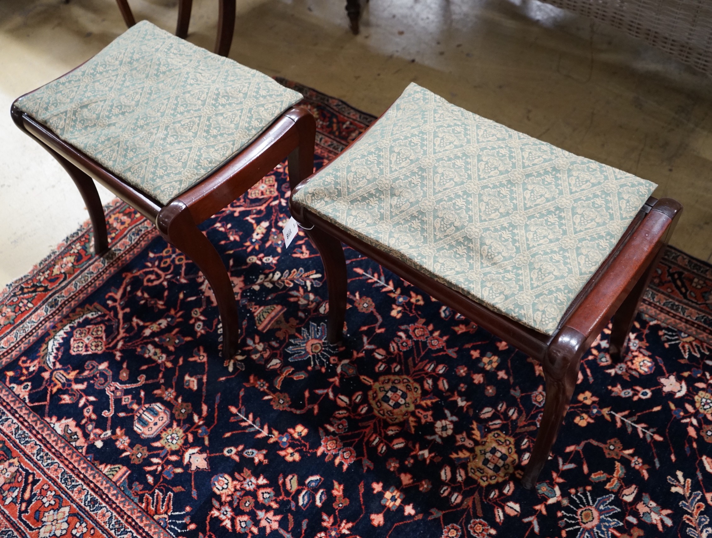 A pair of Regency style cane seat stools